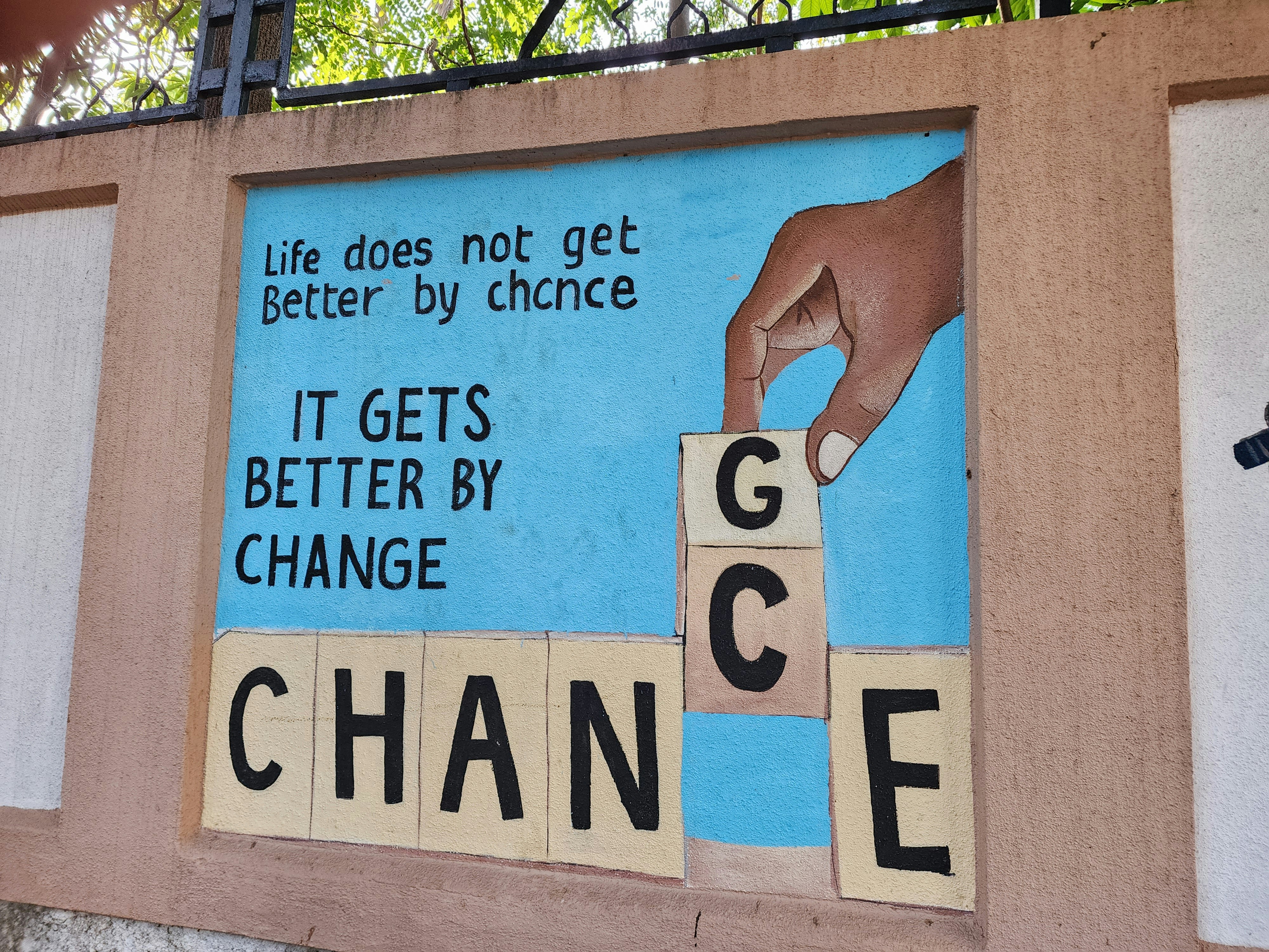 painted mural displaying "Life does not get better by chance, it gets better by change"